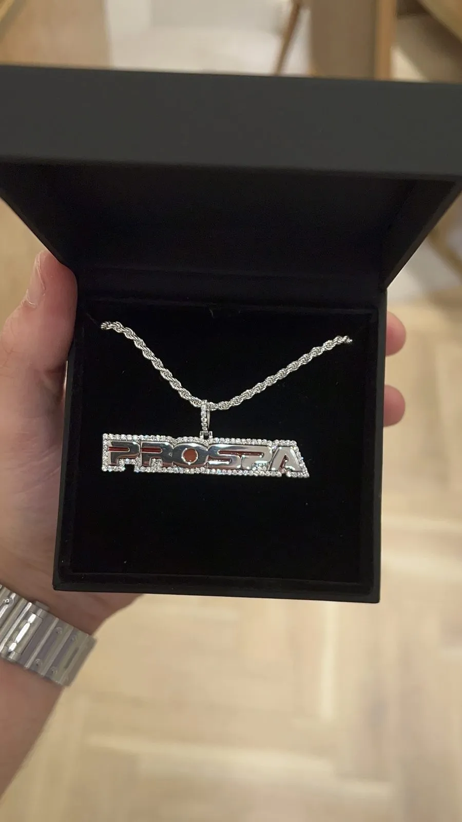 The Prospa name pendant on a rope chain, presented in a black box