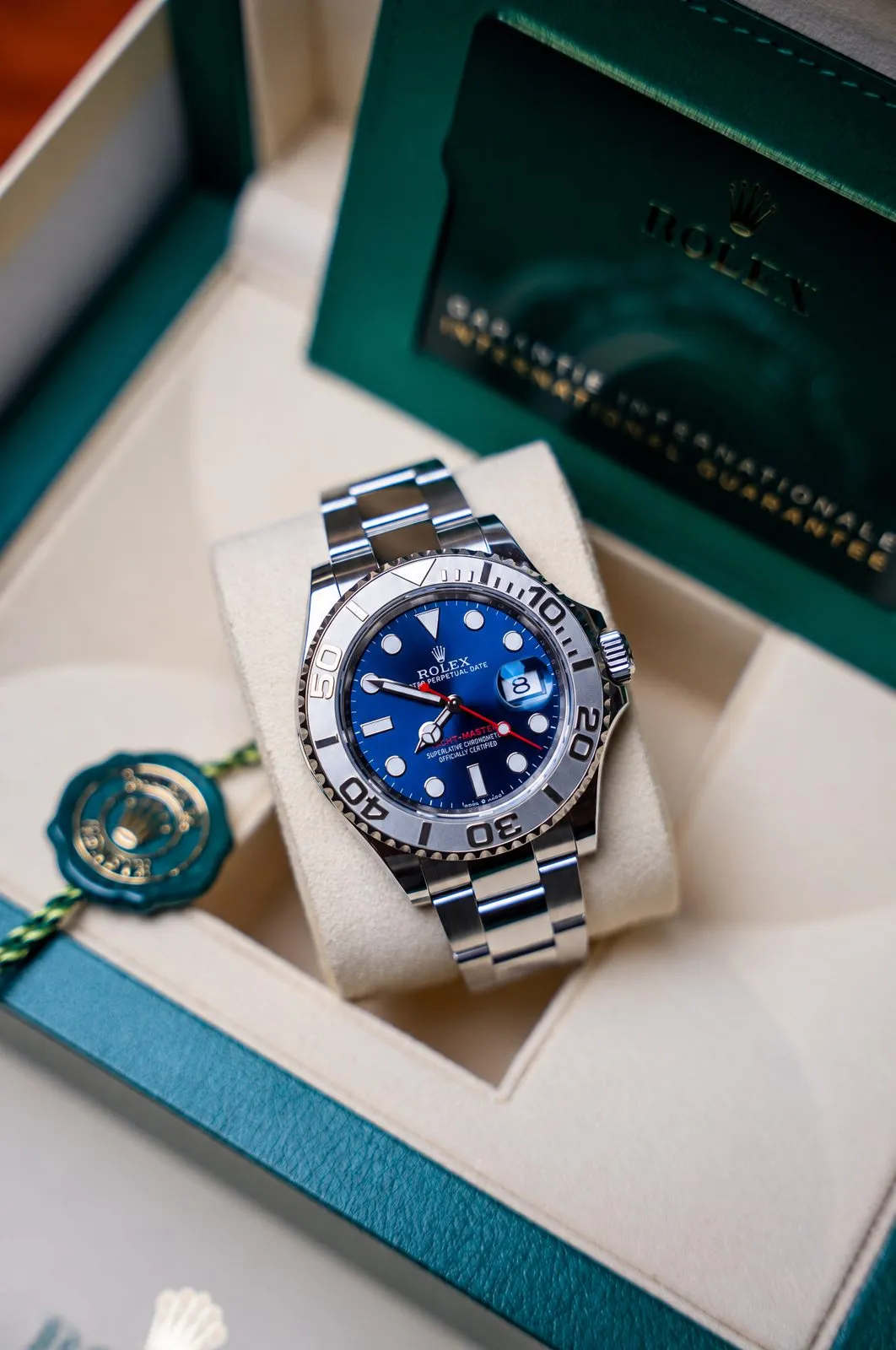 A blue-dial steel watch in its presentation box